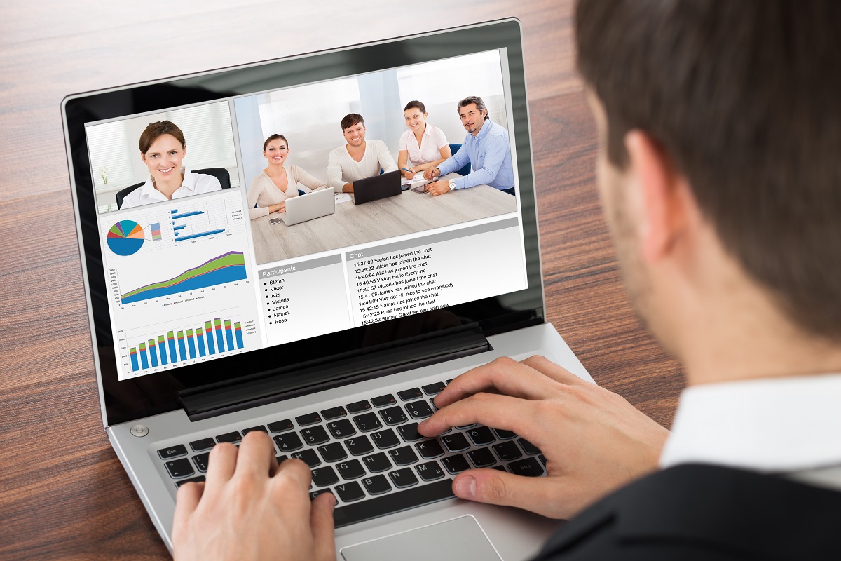 Businessman Video Conferencing With Colleague On Laptop In Office